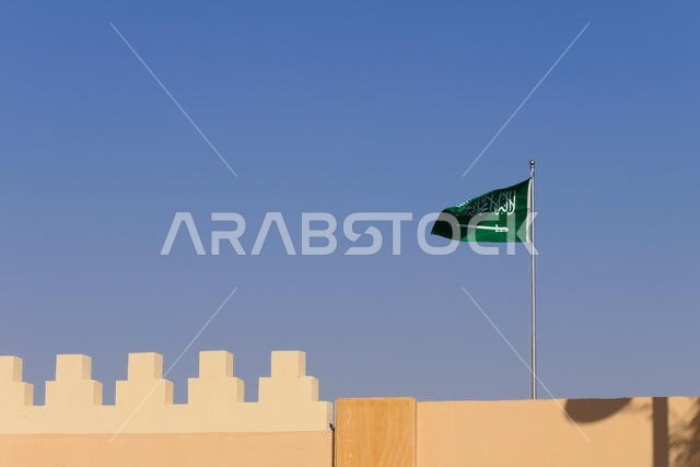 The flag of the Kingdom of Saudi Arabia waving in the historic Diriyah