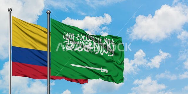Colombia and Saudi Arabia flag waving in the wind against white cloudy blue sky together. Diplomacy concept, international relations.