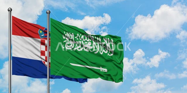 Croatia and Saudi Arabia flag waving in the wind against white cloudy blue sky together. Diplomacy concept, international relations.