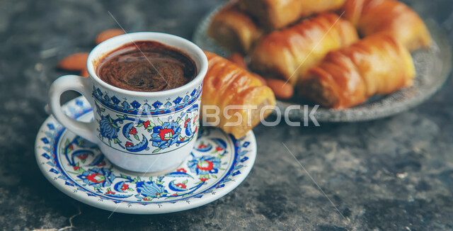 Close-up of a small coffee cup with a delicious baklava plate, oriental sweets, Ramadan sweets, sweets and sugars, delicious candy bars, sweets, delicious desserts, baklava pieces, espresso coffee, delicious hot drinks, and a hot cup of coffee