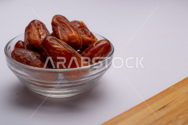 Close-up of a plate of healthy diabetes dates, a meal with a high nutritional value, Ramadan hospitality, types of healthy and delicious dates, white background