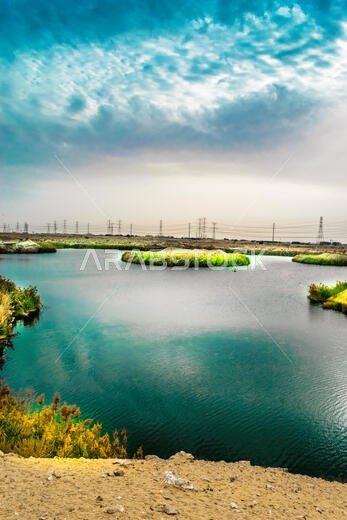 beautiful view of a lake and clouds on the sky and high voltage electricity supply lane in the background beautiful view of a lake and clouds on the sky and high voltage electricity supply lane in the background