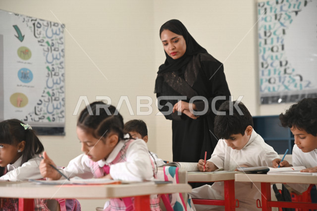 A Saudi Arabian Gulf teacher who monitors male and female students and helps them to read and solve problems, group school activities, education objectives in the prescribed curricula for male and female students in the Kingdom of Saudi Arabia.