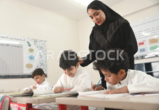 A Saudi Arabian Gulf teacher who monitors male and female students and helps them to read and solve problems, group school activities, education objectives in the prescribed curricula for male and female students in the Kingdom of Saudi Arabia.