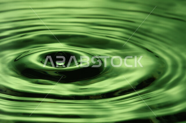 تساقط ثطرة من الماء على بقعة مائية، سطح مائي باللون الأخضر، شكل دائري رائع، خلفية لسطح مائي