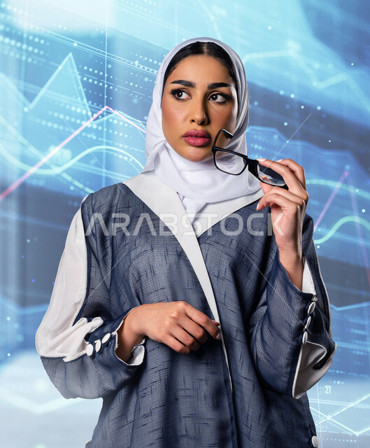 سيدة عربية خليجية سعودية تحمل بيدها نظارات طبية بإيماءات و تعابير وجه و يدين تدل على التفكير و التمعن ، مدموجة بخلفية بها مجموعة أيقونات خاصة بالويب و شبكات الأنترنت بتقنية هولوجرامية ثلاثية الأبعاد ، الإبداع التكنولوجي و تطويره  