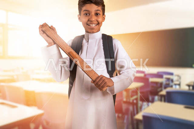 Saudi Arabian Gulf student holding a numbered ruler and wearing school uniform, school backpack, stationery, preparing for the new school year, education in Saudi Arabia, back to school
