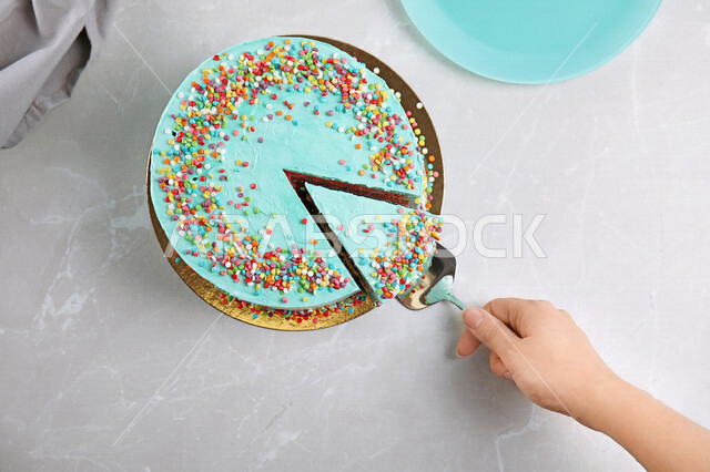 Close-up of a woman's hand taking a piece of cake, a plate of delicious dessert, a cake of delicious cake, oriental dessert, Christmas cake, sweets and sugars