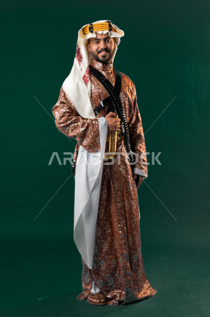 كروما لرجل عربي سعودي خليجي، يرتدي الزي الشعبي التقليدي العريق, دقلة أهل المنطقه الوسطى مع المحزم والخنجر, الإحتفال باليوم الوطني، هوية اليوم الوطني السعودي 92، أزياء سعودية تراثية، يوم التأسيس السعودي، صورة الجسم بالطول الكامل, خلفيه خضراء