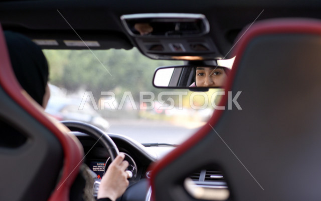 Ksa Car Rear View Reflection of an image of a Saudi Arab Gulf woman driver in the rear ...