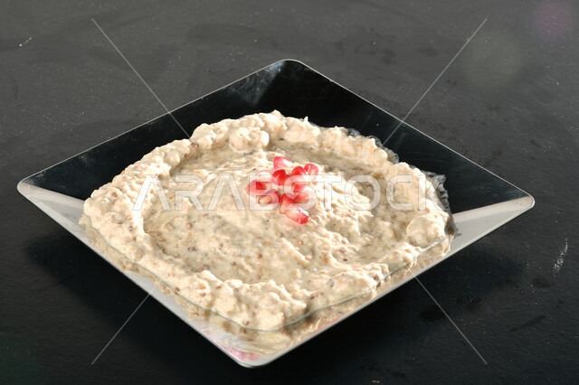 Close-up of a plate of cold Arabic appetizers, a plate of delicious eggplant muttabal, restaurants for oriental Arabic food, delicious meals, oriental Arabic food