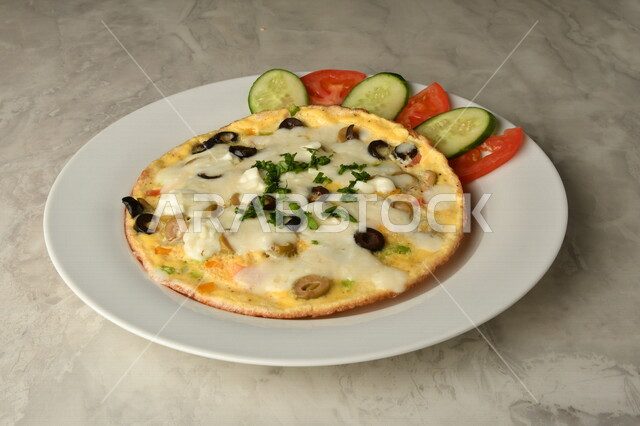 A close-up of an omelette with eggs and olives, traditional Arabic dishes, Arab food, traditional dishes, delicious recipes and dishes, healthy delicious meals, oriental restaurants, omelette eggs, restaurants for oriental Arabic food