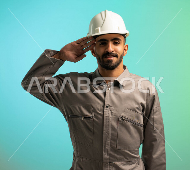 A Saudi Arabian Gulf technical engineer working in the construction sector, wearing a protective helmet, looking at the camera and greeting peace, Saudi professions and jobs, Saudi employment, job opportunities, electrical technician profession, business 