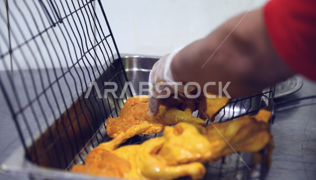 طباخ عربي سعودي خليجي يقوم بتحضير الدجاج للشواء, تتبيل الدجاج, وضع الدجاج على شبك الشواء, دجاج مظبي قيد التحضير, دجاج على الفحم, وجبه صحيه, مطاعم عربيه سعوديه خليجيه