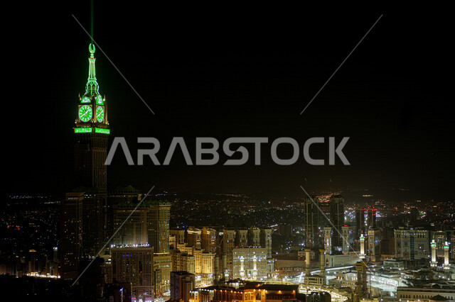 Clock tower in Mecca, Saudi Arabia at night, towers and skyscrapers, clock tower illuminated in green, architectural art, Islamic religious landmarks in Saudi Arabia