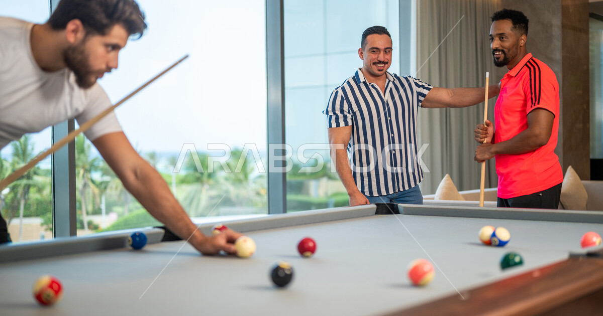 A group of Saudi Arabian Gulf youths wearing casual clothes, playing