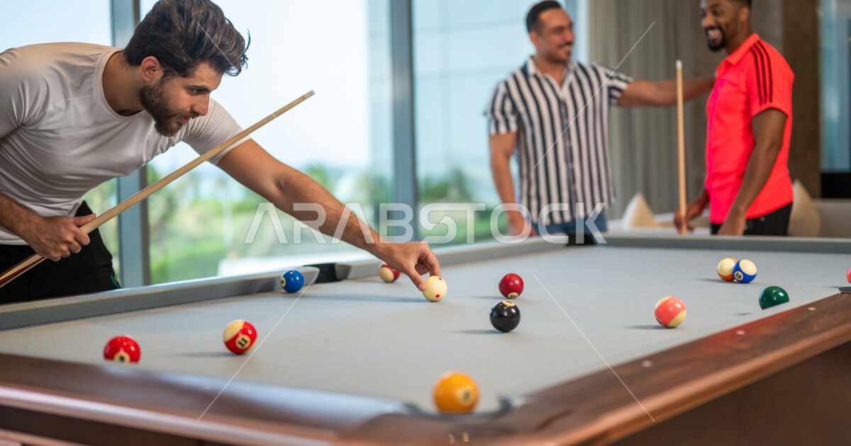A group of Saudi Arabian Gulf youths wearing casual clothes, playing