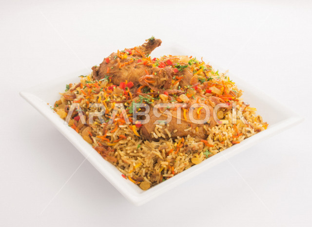 A plate of biryani rice with chicken, spiced rice with nuts and raisins, Indian food, traditional dishes, celebrations and banquets, Indian restaurants in the Kingdom of Saudi Arabia
