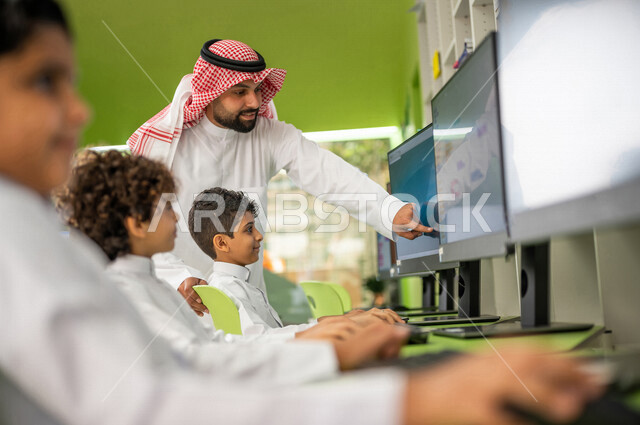 A group of Saudi Arabian Gulf students in an advanced educational school environment, computer lab, advanced e-learning, educational platforms, smart education, promoting science and innovations, innovative schools, quality education, academic schools in 