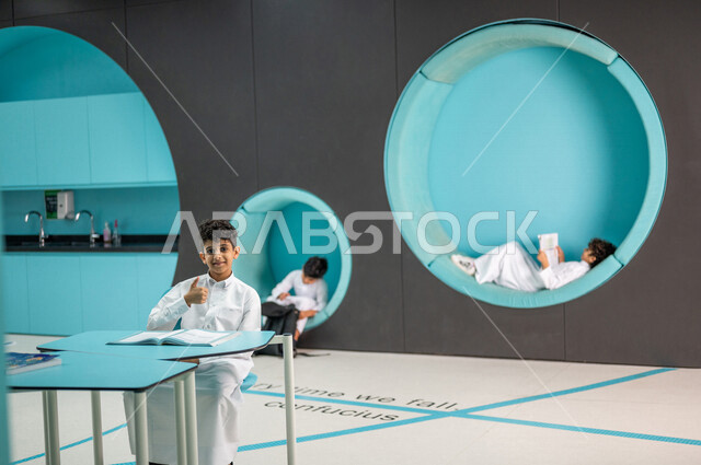 A group of Saudi Arabian Gulf students in an advanced educational school environment, the Montessori education system, smart education, an educational class with advanced technologies, promoting science and innovations, skills development, innovative scho