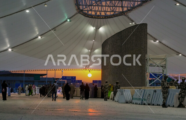 A group of visitors to the House of God in the area of stoning the Jamarat in Makkah Al-Mukarramah in the Kingdom of Saudi Arabia, the pedestrian bridge, stoning the Jamarat, performing Hajj and Umrah, standing at the place of stoning the Jamarat in Mecca