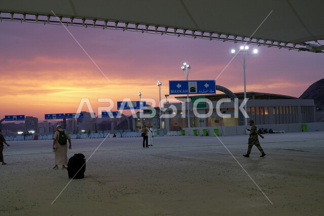 A group of visitors to the House of God in the area of stoning the Jamarat in Makkah Al-Mukarramah in the Kingdom of Saudi Arabia, the pedestrian bridge, stoning the Jamarat, performing Hajj and Umrah, standing at the place of stoning the Jamarat in Mecca