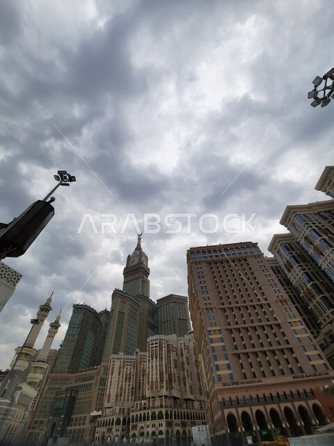 An aesthetic image from inside the Holy Mosque in Mecca, the royal clock tower building in the daytime, performing Hajj and Umrah, worship and getting closer to God, Islamic religious landmarks in the Kingdom of Saudi Arabia