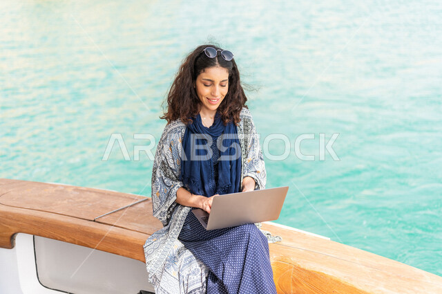 إمرأه عربيه سعوديه خليجيه على متن يخت, إستخدام جهاز الحاسوب المحمول, إدارة الأعمال عن بعد, التسوق الإلكتروني, التواصل الإجتماعي, متعة الإبحار في القوارب والسفن, جولات بحريه على كورنيش جده, رحلات بحريه في مارينا جده, عطله صيفيه, السياحه في السعوديه