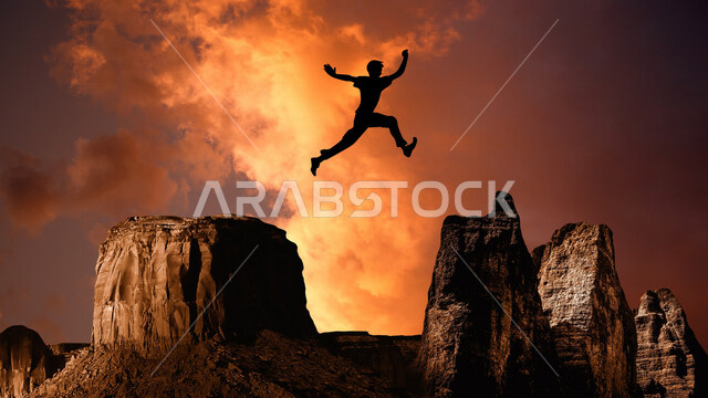 Creative silhouette of a man jumping between two rocks, rock formations, jumping challenges, achieving goals, dangerous sport