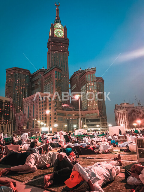 The clock tower in Makkah Al-Mukarramah, Kingdom of Saudi Arabia, performing Hajj and Umrah, worship and getting closer to God, Islamic religious landmarks, Hajj season 2022, clock tower hotels, architectural art, a group of Muslims in the Holy Mosque in 