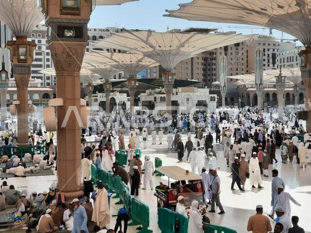The square of the Prophet’s Mosque in Medina, Saudi Arabia, worship and getting closer to God, the Prophet’s Mosque, holy Islamic places, Muslims gathering in the outer complex of the Prophet’s Mosque in Medina, electronic umbrellas, Islamic religious lan
