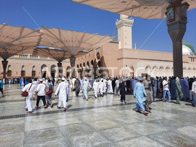 The square of the Prophet’s Mosque in Medina, Saudi Arabia, worship and getting closer to God, the Prophet’s Mosque, holy Islamic places, Muslims gathering in the outer complex of the Prophet’s Mosque in Medina, electronic umbrellas, Islamic religious lan