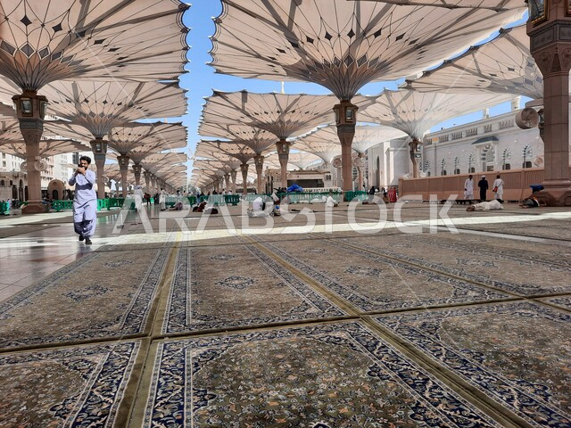 The courtyard of the Prophet’s Mosque in Medina, Saudi Arabia, worship and getting closer to God, the Prophet’s Mosque, holy Islamic places, the external complex of the Prophet’s Mosque in Medina, electronic umbrellas, Islamic religious landmarks