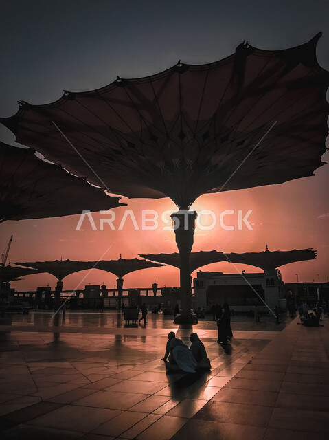 The square of the Prophet’s Mosque in Medina, Saudi Arabia at sunset, the Prophet’s Mosque, the huge electronic umbrellas inside the Prophet’s Mosque, worship and getting closer to God, religious landmarks in Saudi