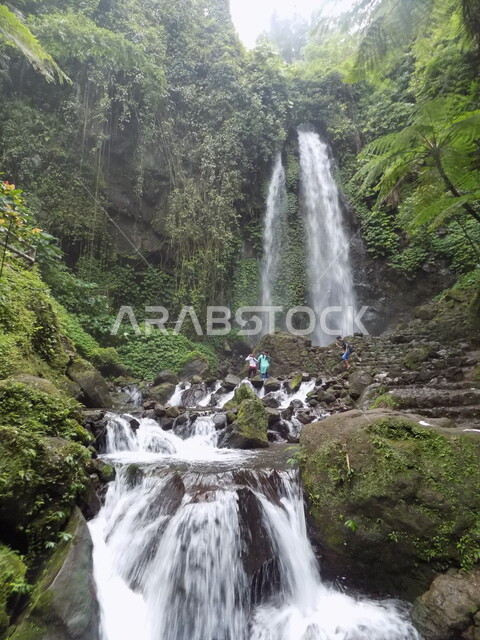 Water flowing on the rocks of one of the waterfalls, a waterfall, the beauty of nature, picturesque nature, natural tourist places, green trees and plants, a stream of water, nature background