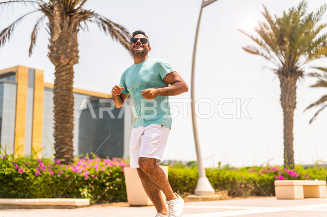 A Saudi Arabian Gulf man practicing morning sports on the Jeddah Corniche, running on the Jeddah Corniche Tourist Walk, Jeddah Waterfront, recreational tourist places in Saudi Arabia, recreation and entertainment, maintaining fitness and good health, recr