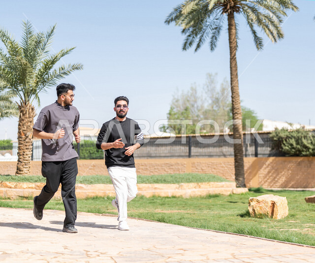 صديقان عربيان خليجيان سعوديان يمارسان رياضة الجري، الصحة واللياقة الجسدية، نشاط بدني في الهواء الطلق، التنزه في الحدائق العامة، تمارين اللياقة البدنية، ممارسة نشاط رياضي، لياقة ورشاقة، طريق ممشى في الحدائق والمنتزهات، نزهه في الهواء الطلق