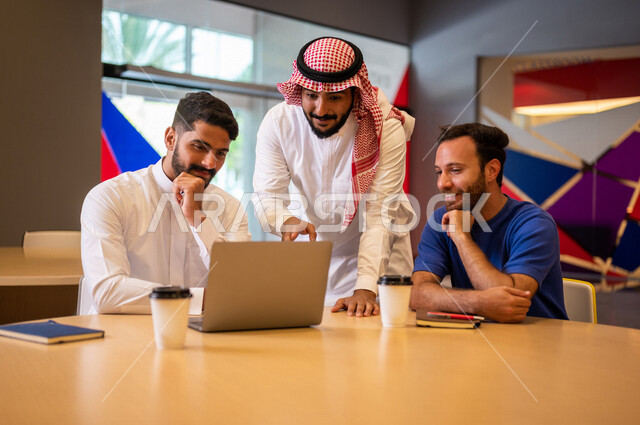 A close-up photo of a group of Arab Saudi Gulf university students in the university cafe, cooperation and sharing, working on the computer, advanced academic universities, Saudi Arab Gulf employees in the company cafe, conversations and discussions, busi