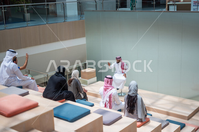 A picture from the back of Saudi Arabian Gulf university students in the lecture hall at the university, listening to the lecture, workshops, training courses, advanced academic universities, Saudi Arab Gulf employees in a company, business meeting, dialo