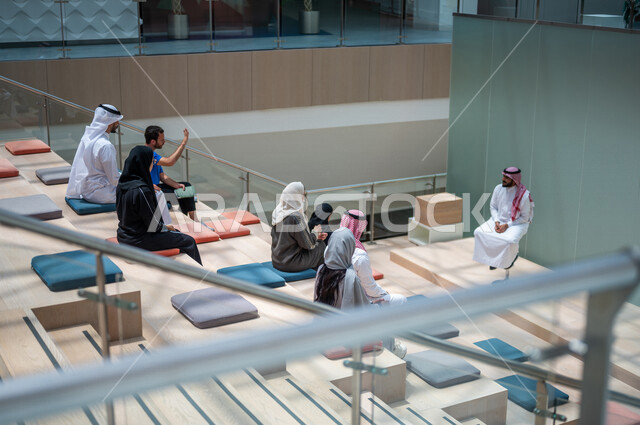 A picture from the back of Saudi Arabian Gulf university students in the lecture hall at the university, listening to the lecture, workshops, training courses, advanced academic universities, Saudi Arab Gulf employees in a company, business meeting, dialo