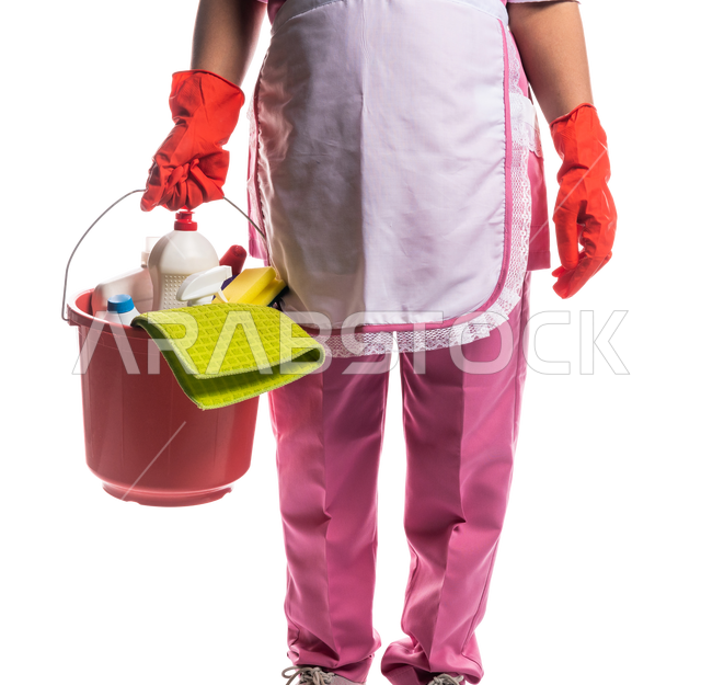 Closeup of a cleaning lady wearing gloves and apron, holding a bucket of household cleaning