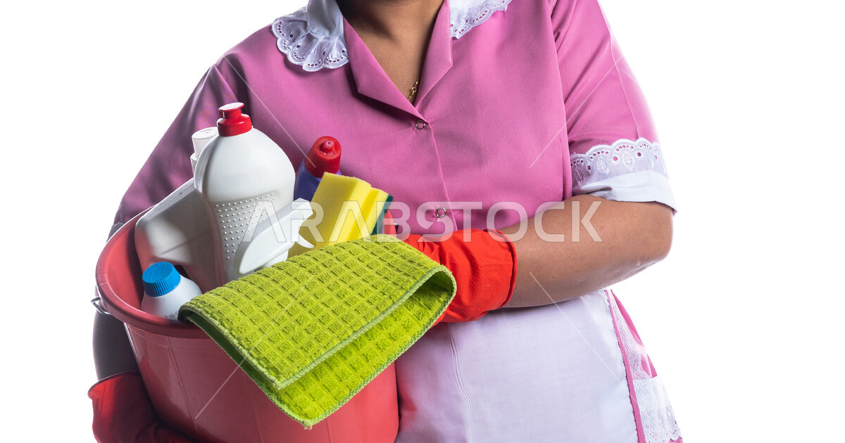 Portrait of a cleaning lady wearing gloves and apron, holding a bucket ...