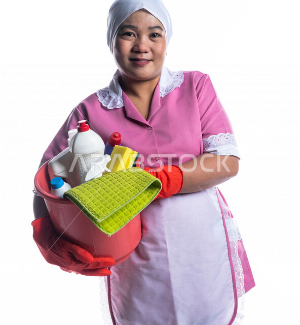 Portrait of a cleaning lady wearing gloves and apron, holding a bucket ...