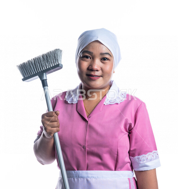Portrait of a cleaning lady wearing gloves and apron, holding a hand ...