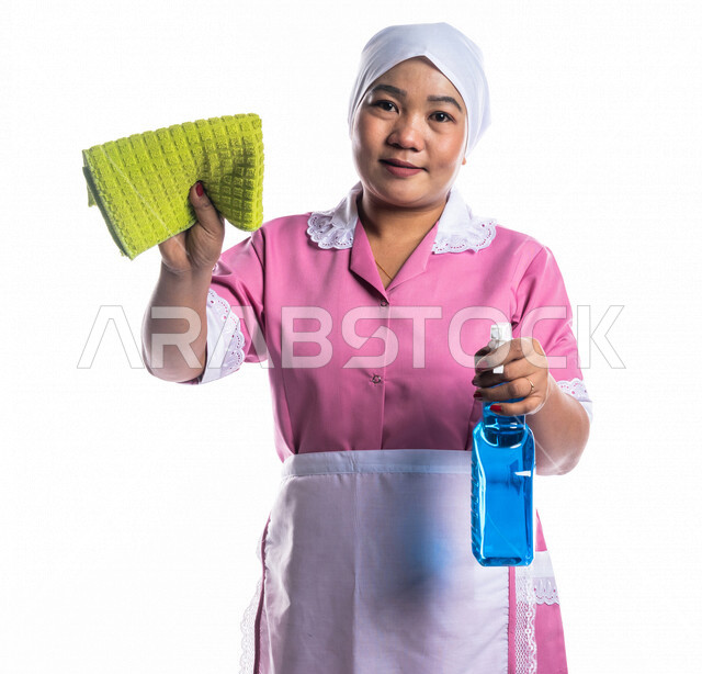 Portrait of a cleaning lady wearing an apron, carrying in her hand ...