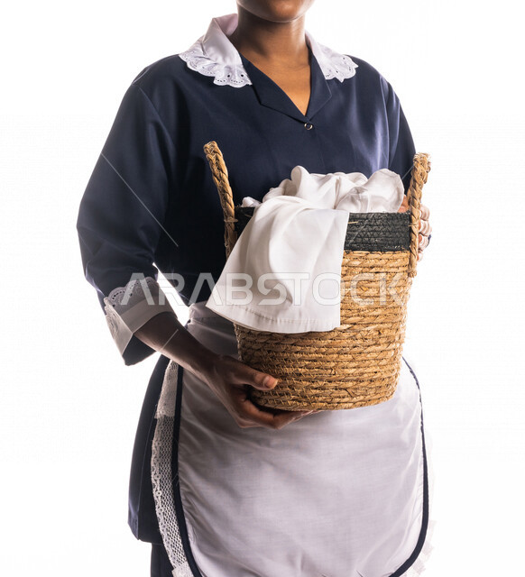 Close-up portrait of a cleaning lady wearing an apron, carrying a ...