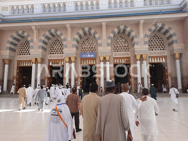 مجموعة من المصلين في ساحة المسجد النبوي الشريف في المدينة المنورة بالمملكة العربية السعودية، العبادة والتقرب الى الله، الحرم النبوي الشريف، أماكن إسلامية مقدسة، إسلاميات وعبادة، معالم دينية إسلامية، أبواب الحرم المكي
