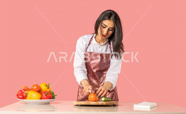 Portrait of an Arab woman, standing in front of a table with a group of fresh vegetables, preparing salads and healthy dishes, healthy diet concept, housewife, healthy eating concept, healthy meal, housekeeping, colorful background, fresh vegetables