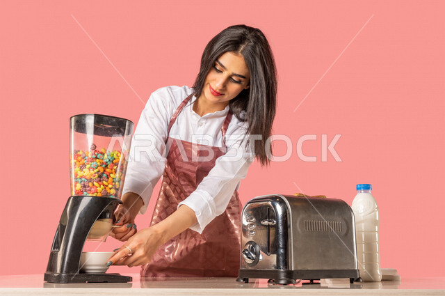 Portrait of an Arab woman, preparing morning breakfast on the kitchen table, following a healthy diet, preparing corn flakes in a white plate, housewife, healthy eating concept, healthy breakfast, healthy breakfast, housekeeping