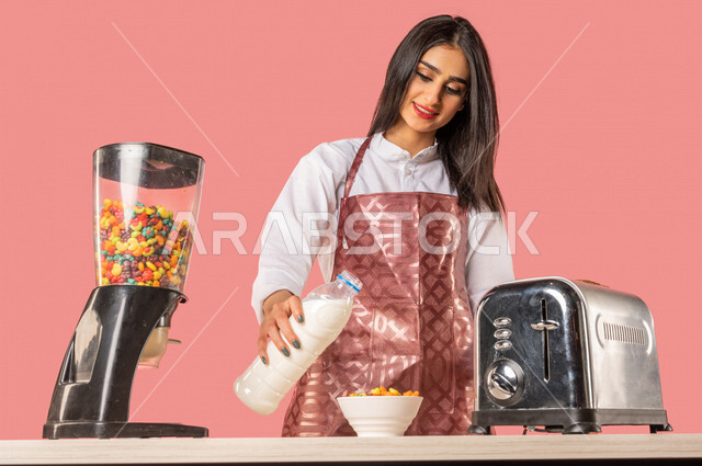 Portrait of an Arab woman, preparing morning breakfast on the kitchen table, following a healthy diet, preparing corn flakes in a white plate, housewife, healthy eating concept, healthy breakfast, pouring milk over cereal, healthy breakfast, housekeeping